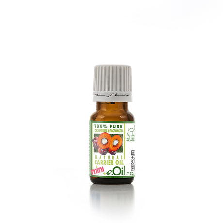 A bottle of Batana Kernel Carrier Oil with a label indicating that it is 100% pure, cold pressed, and natural carrier oil.