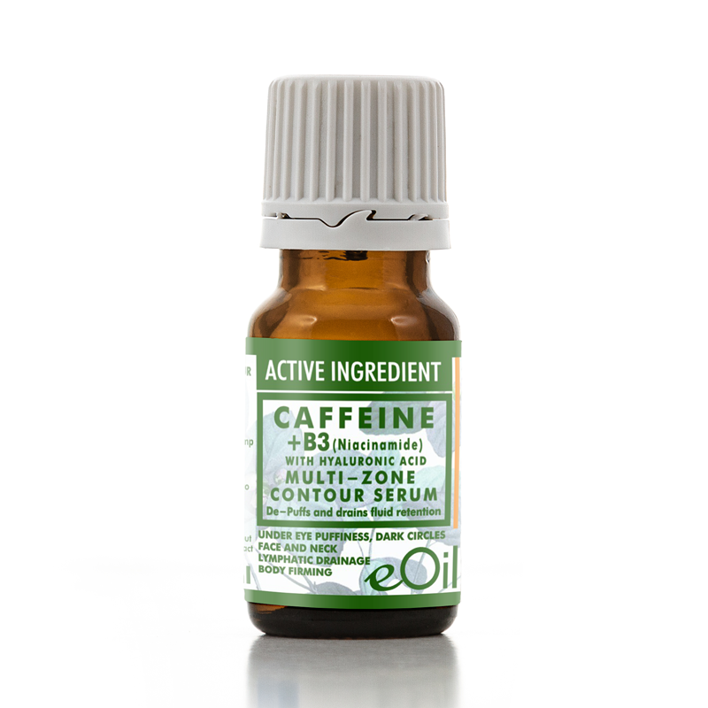 A small amber glass bottle of eOil Caffeine + B3 Multi-Zone Contour Serum with a white ribbed cap and a green and white label, set against a plain white background with a soft reflection.