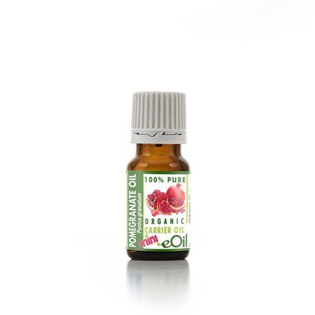 Bottle of pomegranate oil with a green label on a white background