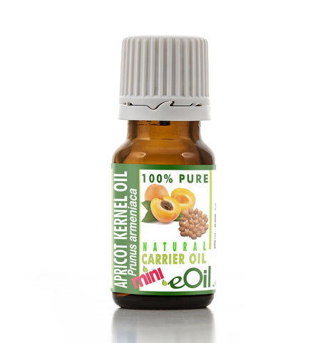 Bottle of apricot kernel oil with a green label on a white background