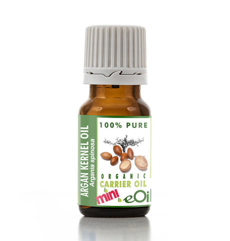 Bottle of argan kernel oil with a green label on a white background