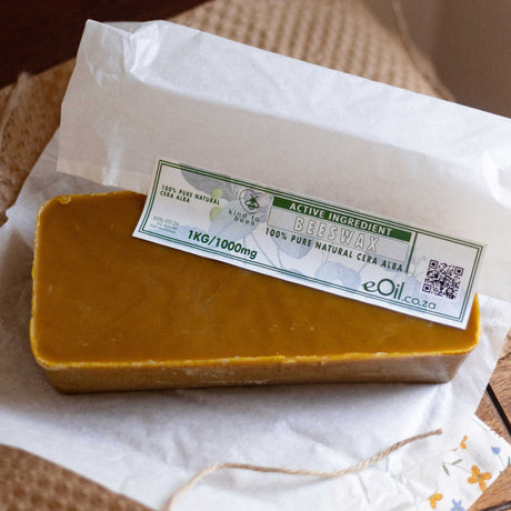 Block of beeswax with a label on a white paper background 1 kg