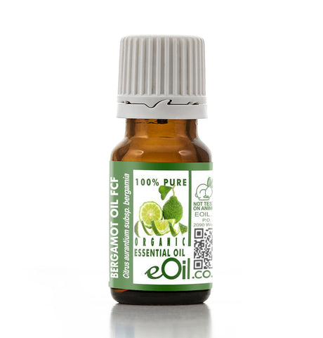 Bottle of Bergamot oil with a green label on a white background