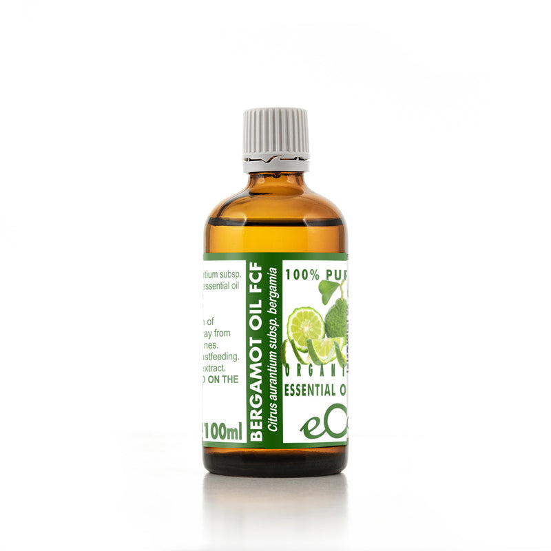 Bottle of bergamot oil with a green label on a white background