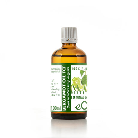 Bottle of bergamot oil with a green label on a white background