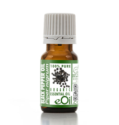 Bottle of black pepper essential oil with a green label on a white background