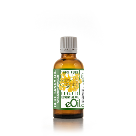 Bottle of Blue Tansy essential oil with a green label on a white background