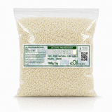 A clear plastic bag filled with small off-white beeswax pellets, featuring a green and white label with the brand name eOil and product details.
