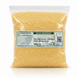 A 1kg clear plastic bag filled with natural yellow beeswax pellets, featuring a green and white label with product details and the brand eOi.co.