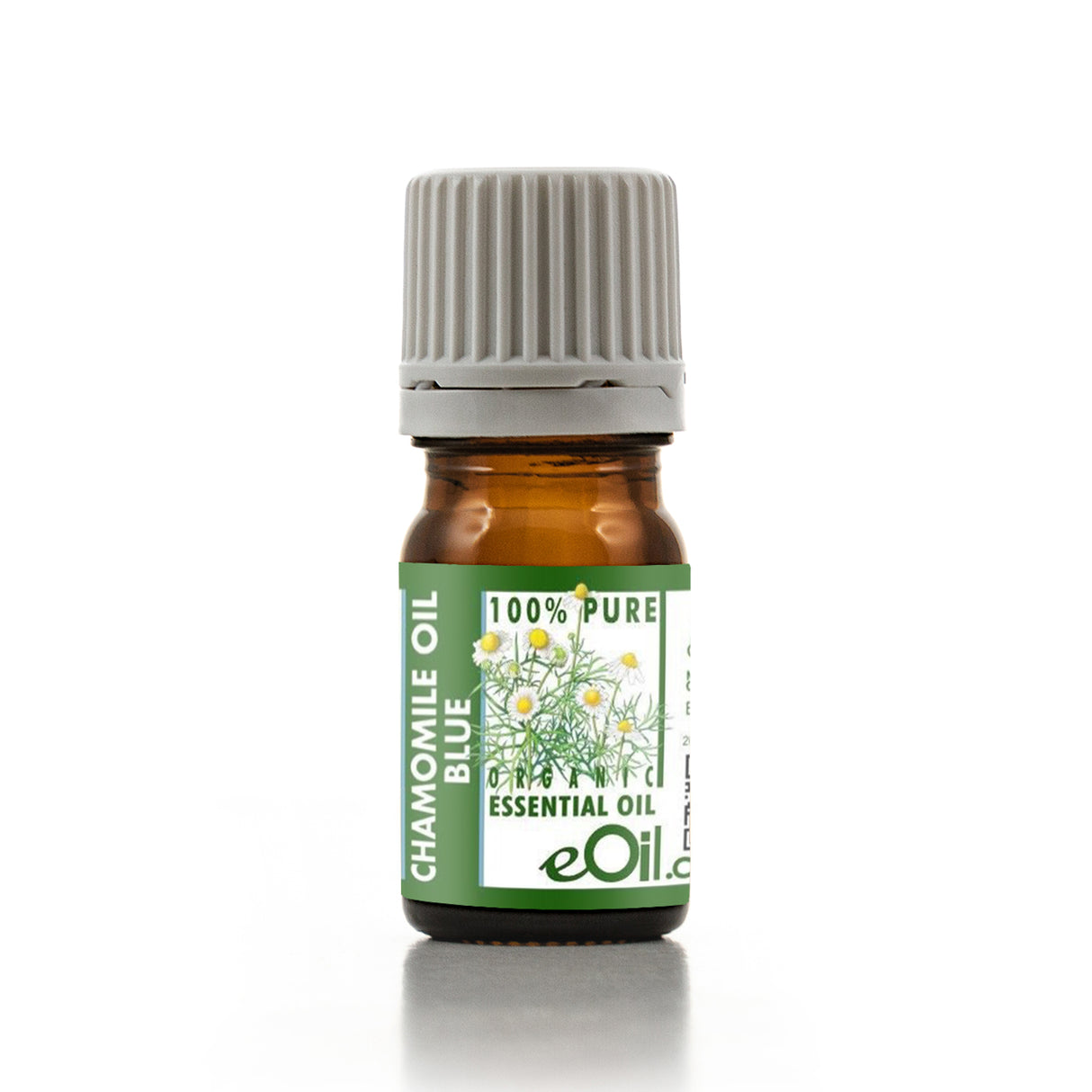 Bottle of chamomile essential oil with a green label on a white background