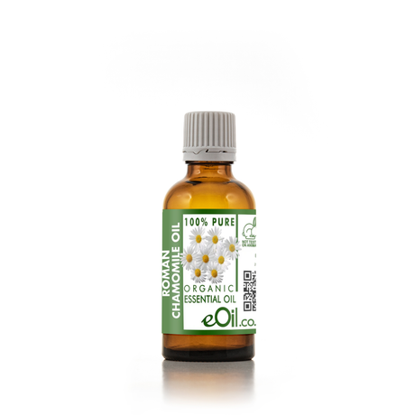 Bottle of Roman Chamomile essential oil with a green label on a white background