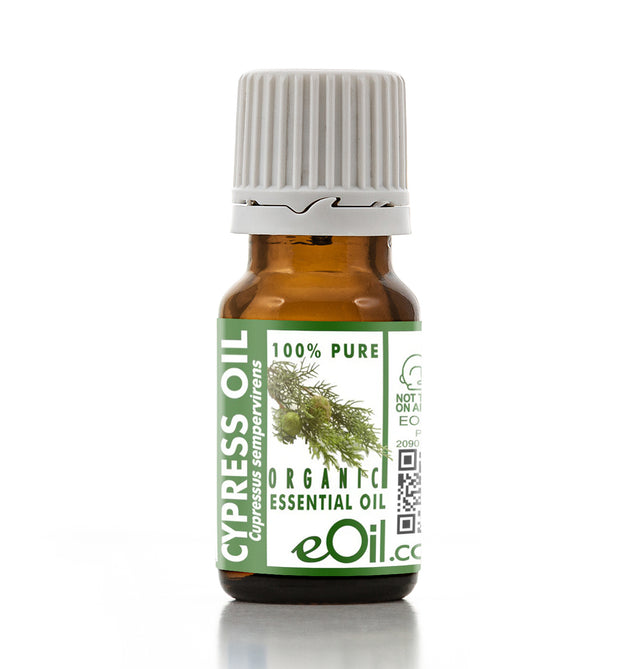 Bottle of Cypress essential oil with a green label on a white background