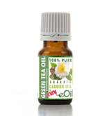 Bottle of green tea oil with a white label on a white background