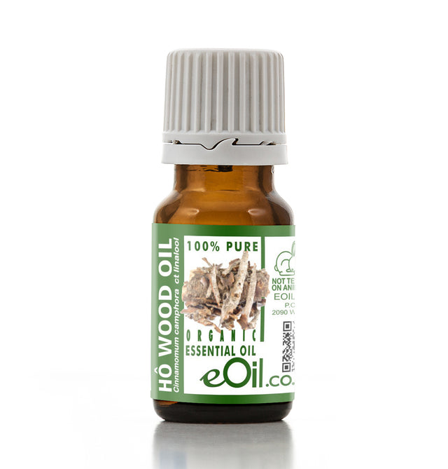 Bottle of Ho Wood oil with a green label on a white background