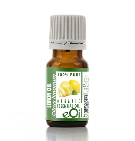 Bottle of lemon essential oil with a green label on a white background