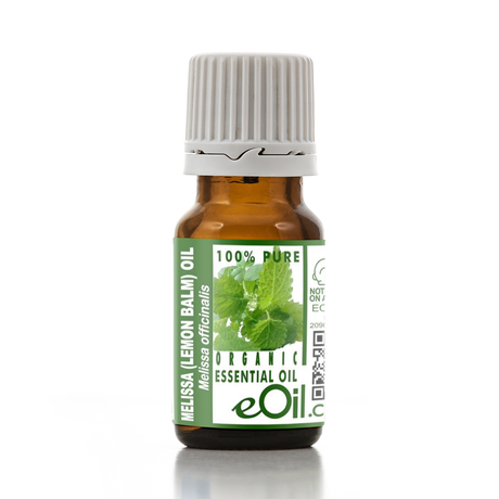 Bottle of Melissa (Lemon Balm) essential oil with a green label on a white background