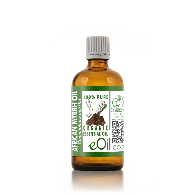An amber glass bottle of eOil Co. African Myrrh Essential Oil with a white ribbed cap and a green and white label, set against a plain white background with a soft reflection.
