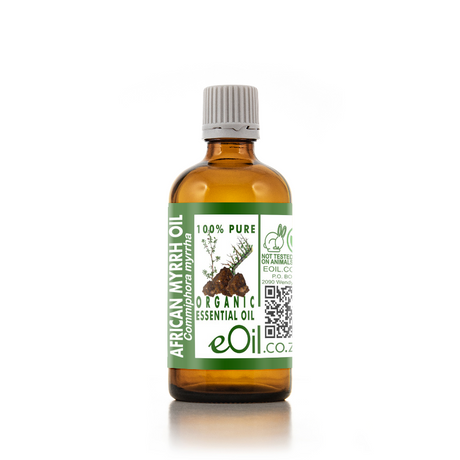 An amber glass bottle of eOil Co. African Myrrh Essential Oil with a white ribbed cap and a green and white label, set against a plain white background with a soft reflection.