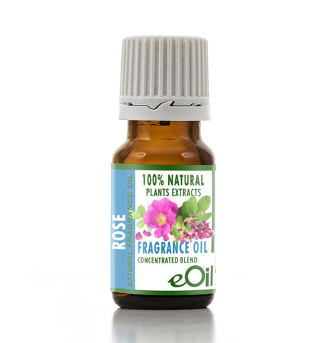 A small amber glass bottle of eOil Rose Fragrance Oil with a white ribbed cap, featuring a colorful label with rose illustrations and text indicating it is a 100% natural plants extracts concentrated blend.