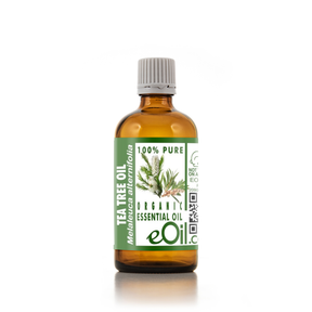Bottle of tea tree oil with a green label on a white background 100 ml bottle