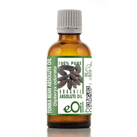 A bottle of eOil Tonka Bean Absolute Oil with an amber glass body, a gray ribbed cap, and a green and white label featuring a picture of tonka bean pods.