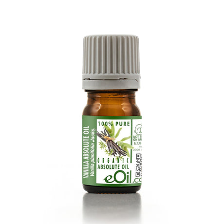 Bottle of vanilla absolute oil with a green label on a white background
