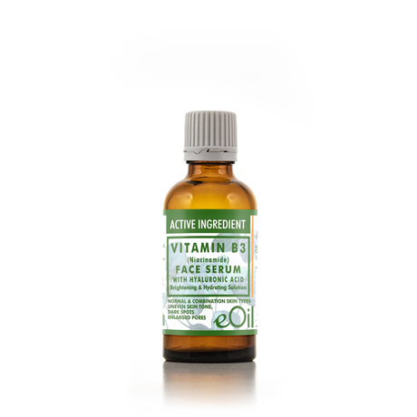 An amber glass bottle of eOil Vitamin B3 Face Serum with a white and green label and a gray ribbed cap, set against a plain white background.