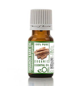 Bottle of cinnamon bark essential oil with a green label on a white background