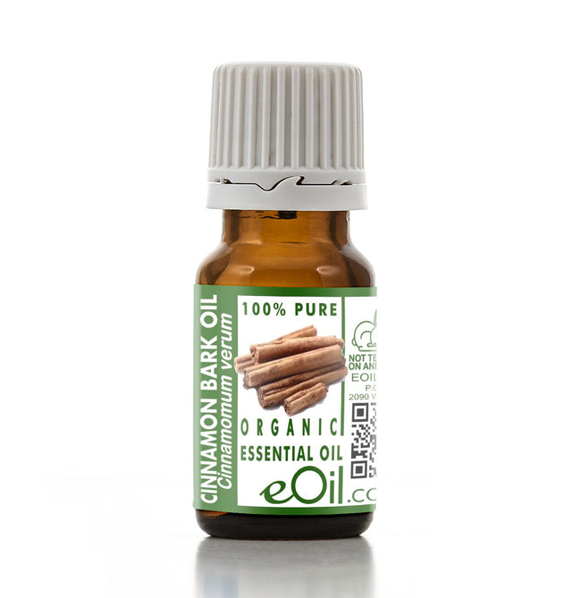 Bottle of cinnamon bark essential oil with a green label on a white background