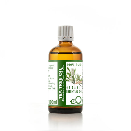 Bottle of tea tree oil with a green label on a white background